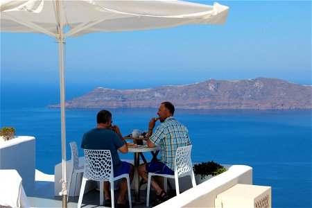 Two Men Eating With Sea View photo