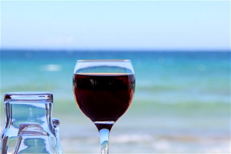 Red Beverage In Glass Near Beach