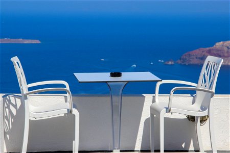 Two Chairs And Table On Terrace Near Sea