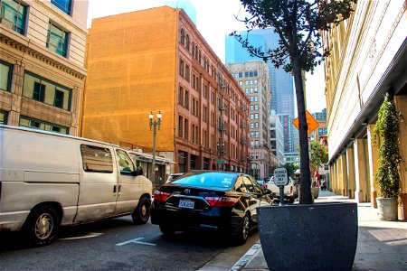 Traffic In Street With Tall Buildings photo