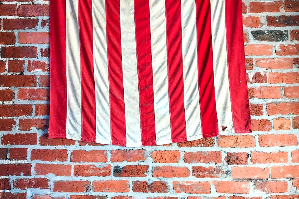 Stripes Of American Flag On Brick Wall photo