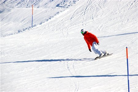 Skier On Snowboard Down Slope photo
