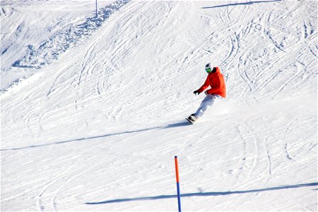 Skier Snowboarding Down Slope photo