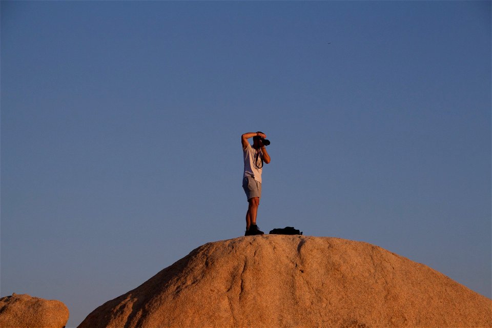 Man Photographing On Hill