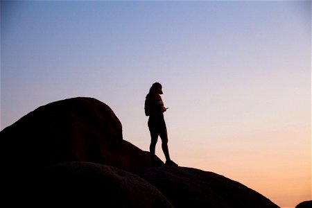 Girl Standing On Rock