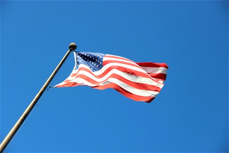 American Flag Flapping On Pole photo