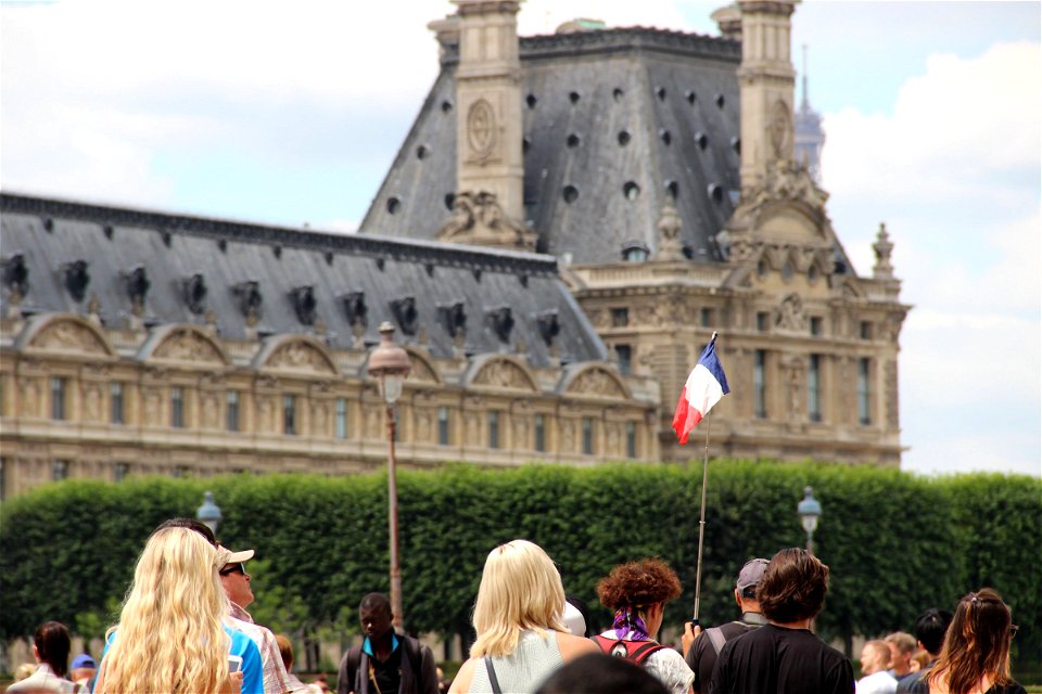 People With French Flag Near Louvre