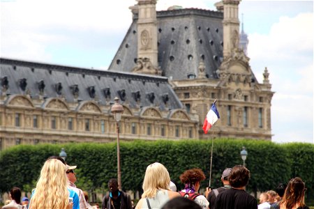 People With French Flag Near Louvre photo