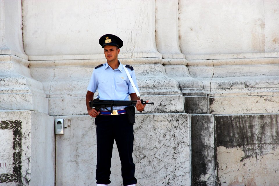 Police Officer In Front Of Old Building