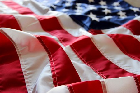 American Flag With Folds On Flat Surface photo