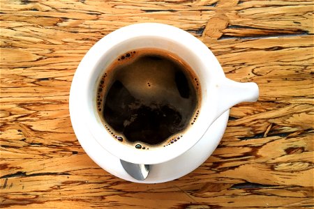 Cup Of Coffee On Wooden Surface photo