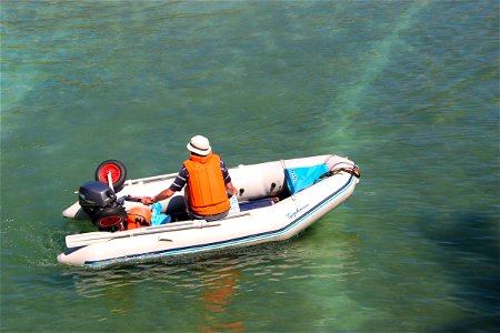 Man In Small Motorboat In Water photo