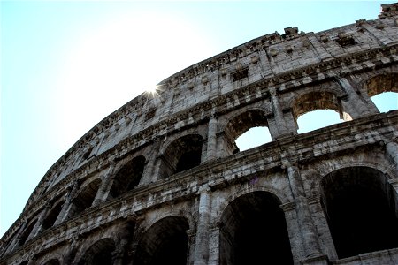 Sun Shining Behind Roman Coliseum