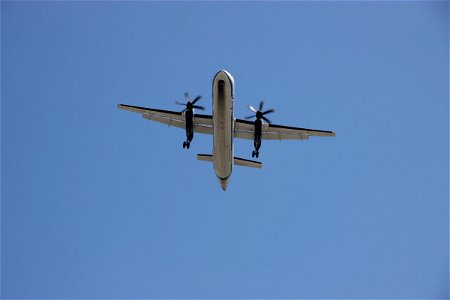 Twin Propeller Airplane Flying Overhead photo