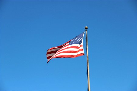 American Flag Waving On Pole photo