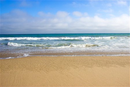 Ocean Waves on Beach Sand photo
