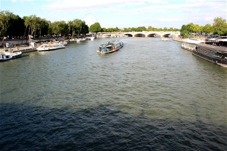 Tour Boat on River by Bridge photo