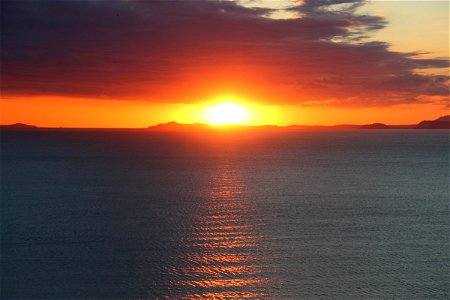 Sunset Behind Island on Ocean
