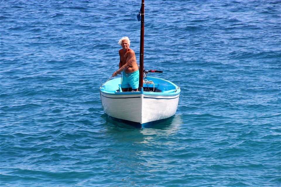 Old Man in Small Sailboat photo