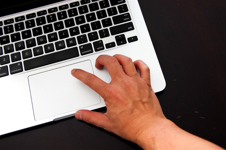 Hand Clicking on Laptop
