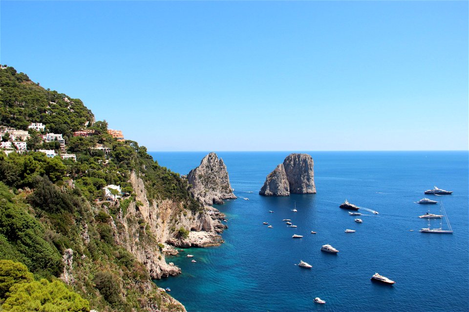 Boats on Ocean by Cliffs photo