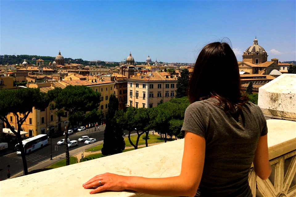 Woman Looking Out of Buildings photo