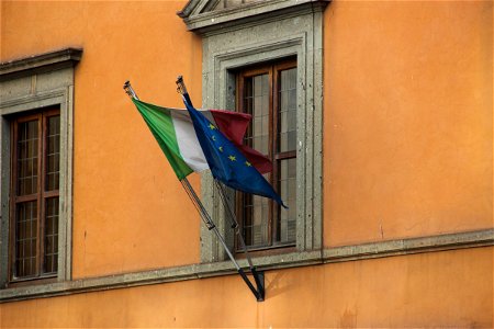 Flag of Italy and European Union on Side of Building photo