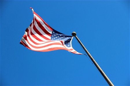 American Flag Waving on Pole photo