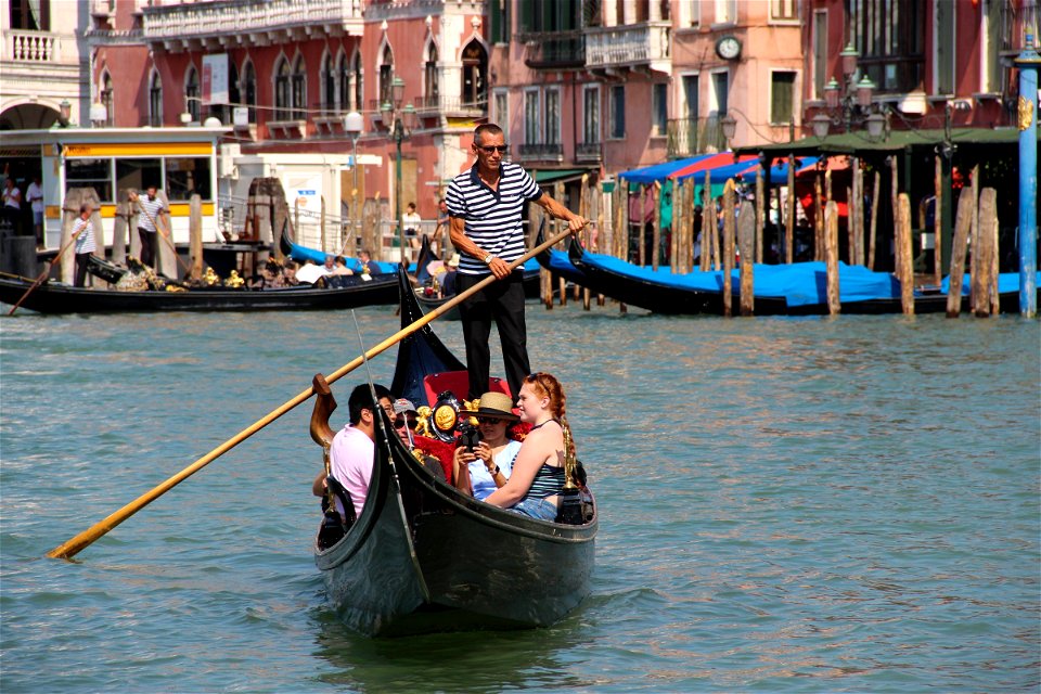 Man Rowing with Tourists in Gondola photo
