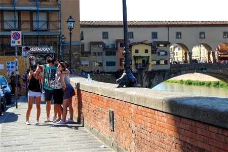 Tourists Taking Selfie by Bridge photo