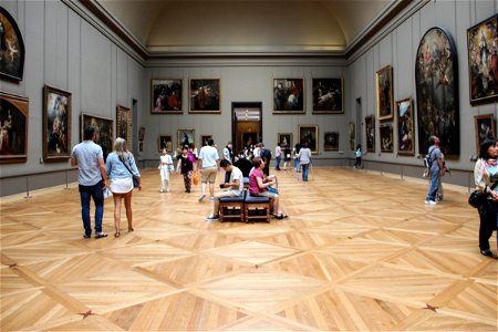 People in Museum Room with Paintings photo