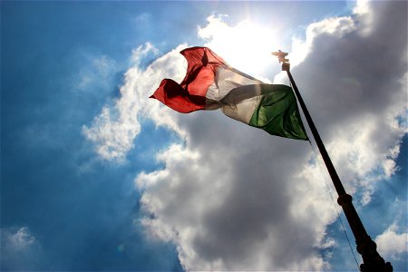 Italian Flag Under Sun & Clouds