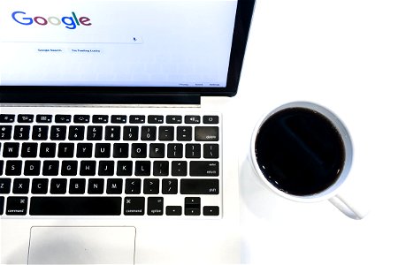Laptop Next to Coffee Cup photo