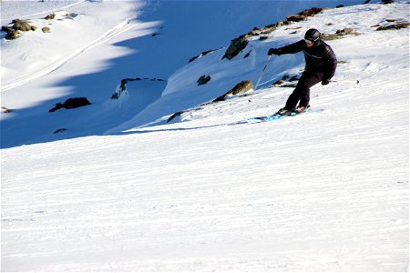 Man Skiing Down Slope photo