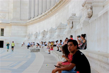 People Sitting on Steps of Palace photo