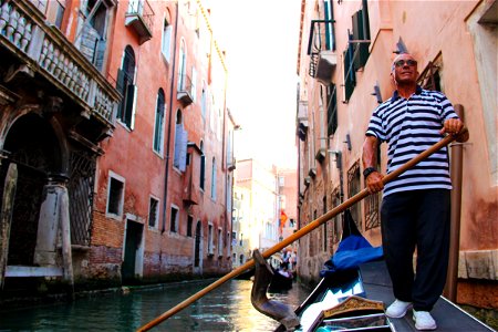 Man Rowing Gondola Through Canals photo