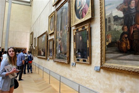 People Looking at Paintings in Museum photo
