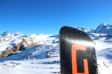 Snowboard in Front of Mountains