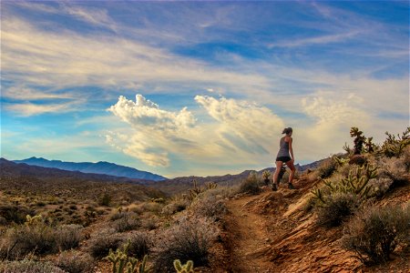 Woman Hiking on Desert Path photo