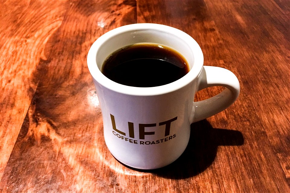 Mug of Coffee on Wood Table photo