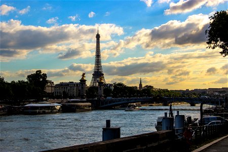 Eiffel Tower by River Under Clouds photo