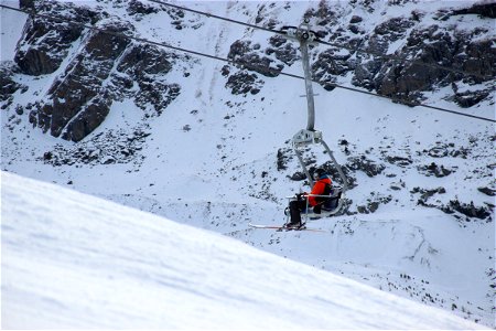 Man Riding on Ski Lift photo