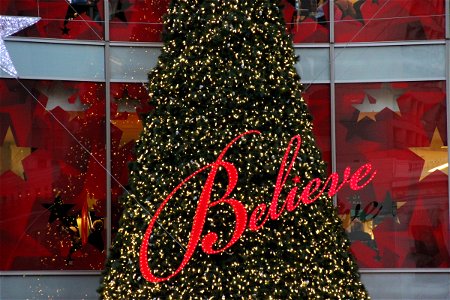 Believe Sign in Front of Christmas Tree photo
