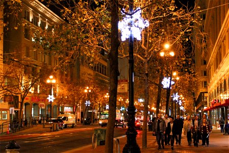 People Walking Down City Street at Night photo