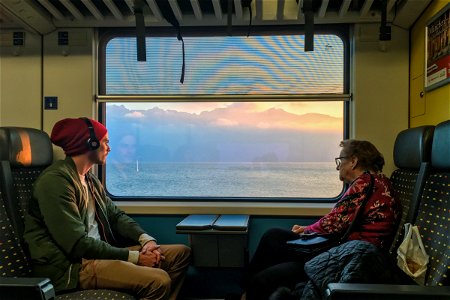 Young Man & Elderly Woman on Train photo