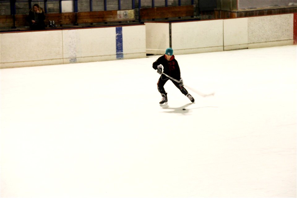 Boy on Ice Rink Playing Hockey