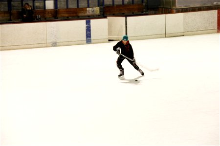 Boy on Ice Rink Playing Hockey photo