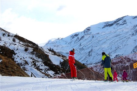 Skiers Standing on Mountain Slope photo