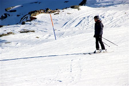 Man Slowly Skiing in Snow photo