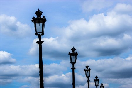 Lamp Posts under Sky with Clouds
